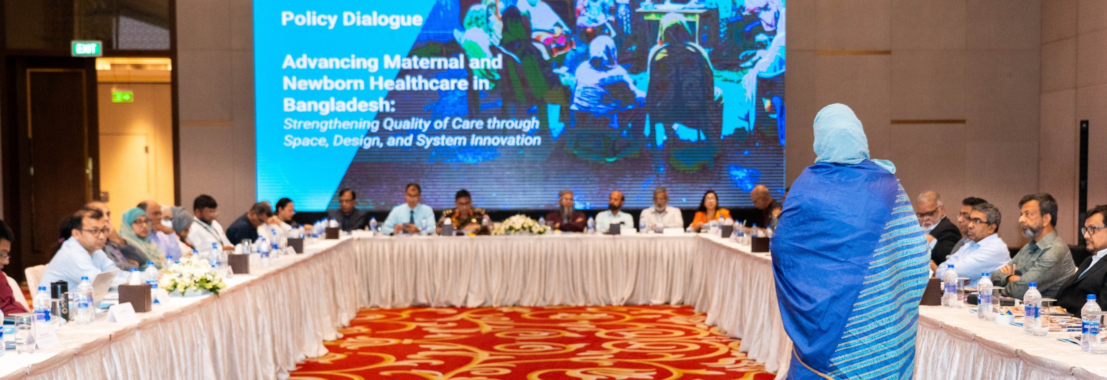 Health care leaders gather around a table for a Policy Dialogue in Bangladesh